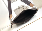 Open top zip crossbody bag with dark interior and tan strap trim