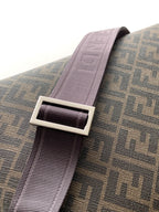Purple crossbody strap with rectangular metal buckle on monogram bag