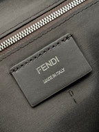 Leather logo patch reading FENDI MADE IN ITALY on textured bag