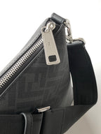 Fendi bag close-up of top zipper pull and logo hardware on dark fabric