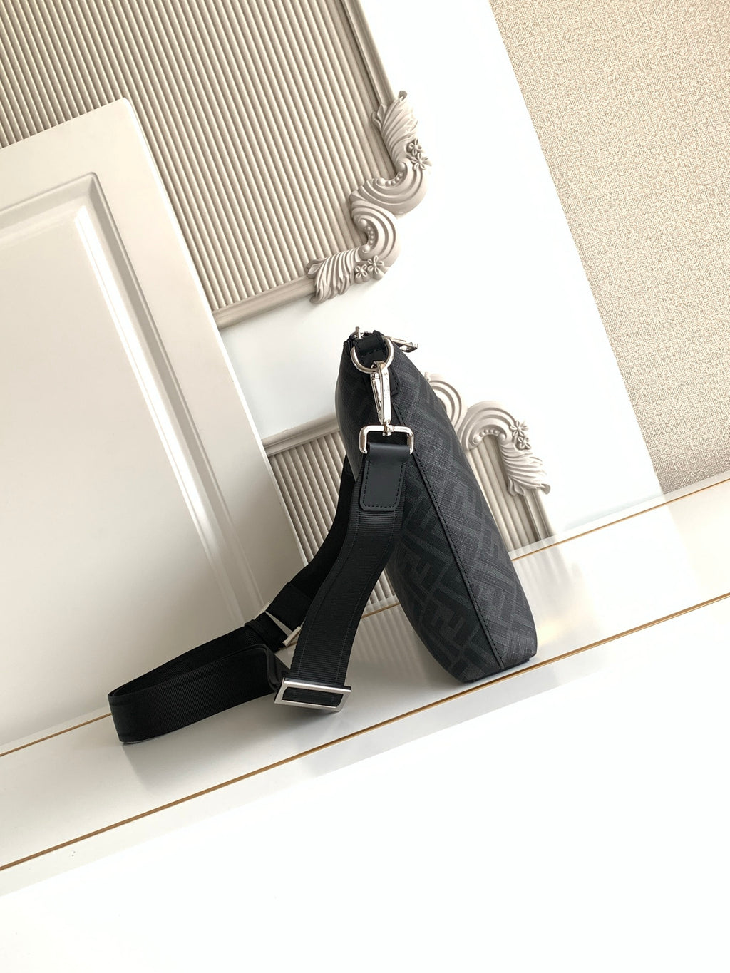 Fendi bag in dark logo fabric with adjustable shoulder strap and silver hardware