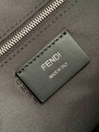Fendi leather brand tag reading FENDI MADE IN ITALY on dark bag