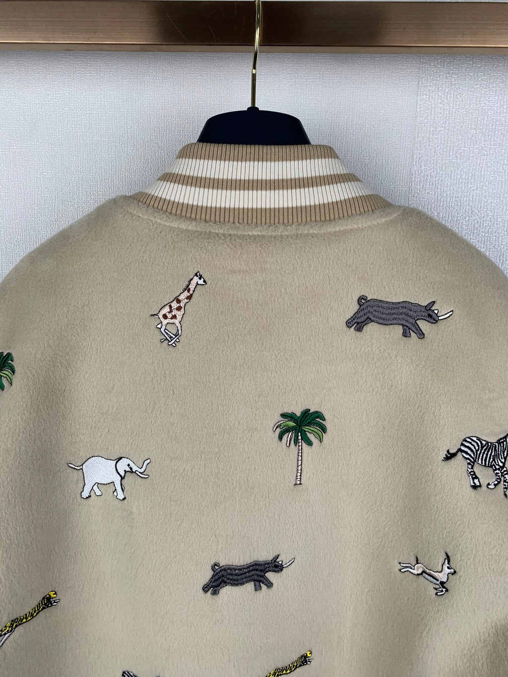 Beige Louis Vuitton jacket back with scattered animal and palm embroidery, ribbed collar