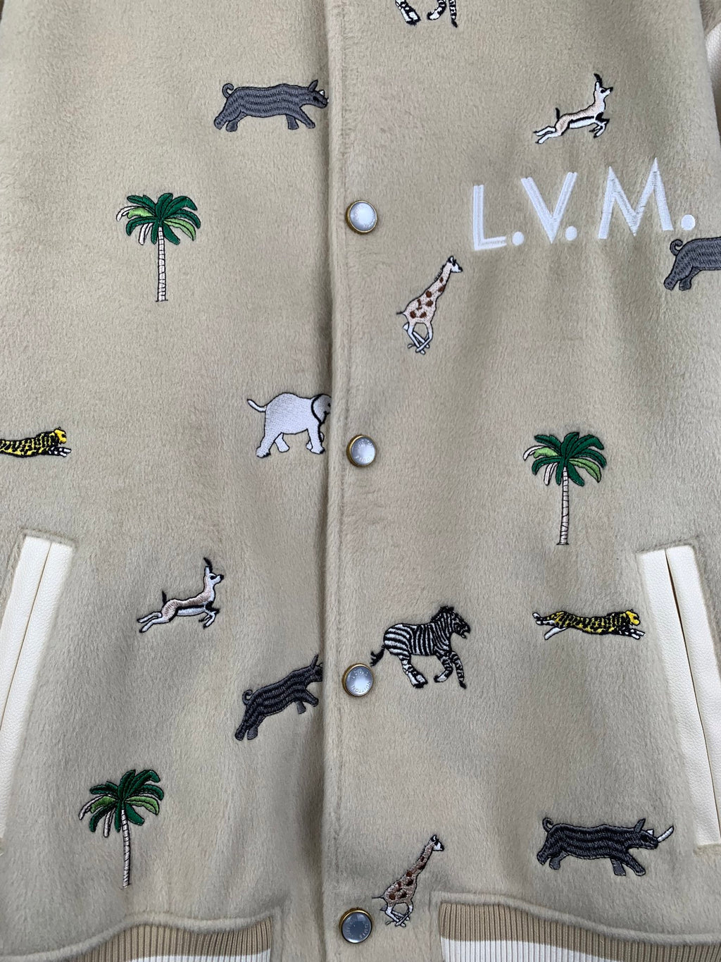 Beige Louis Vuitton jacket front detail with animal and palm embroidery and button placket