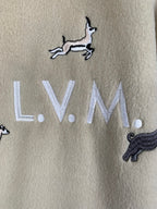 Beige Louis Vuitton sweatshirt-style fabric with embroidered L.V.M. and zebra and dog motifs