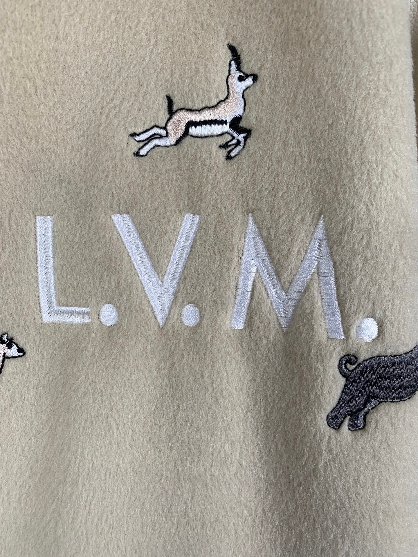 Beige Louis Vuitton sweatshirt-style fabric with embroidered L.V.M. and zebra and dog motifs