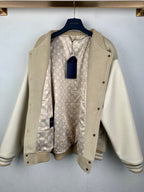 Beige varsity jacket with monogram-lined interior and front button placket