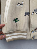 Beige Louis Vuitton jacket cuff and striped hem with animal and palm embroidery
