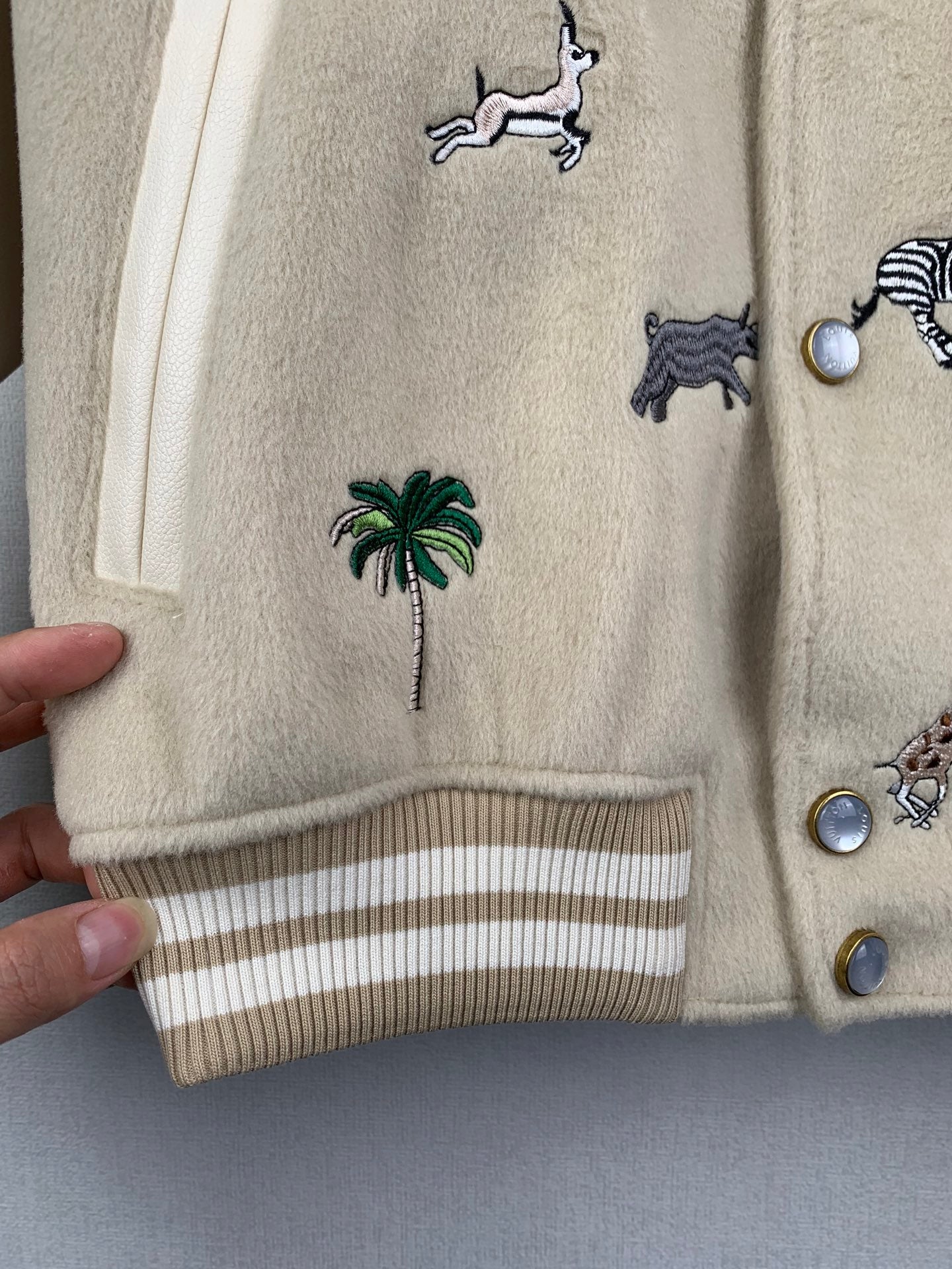 Beige Louis Vuitton jacket cuff and striped hem with animal and palm embroidery