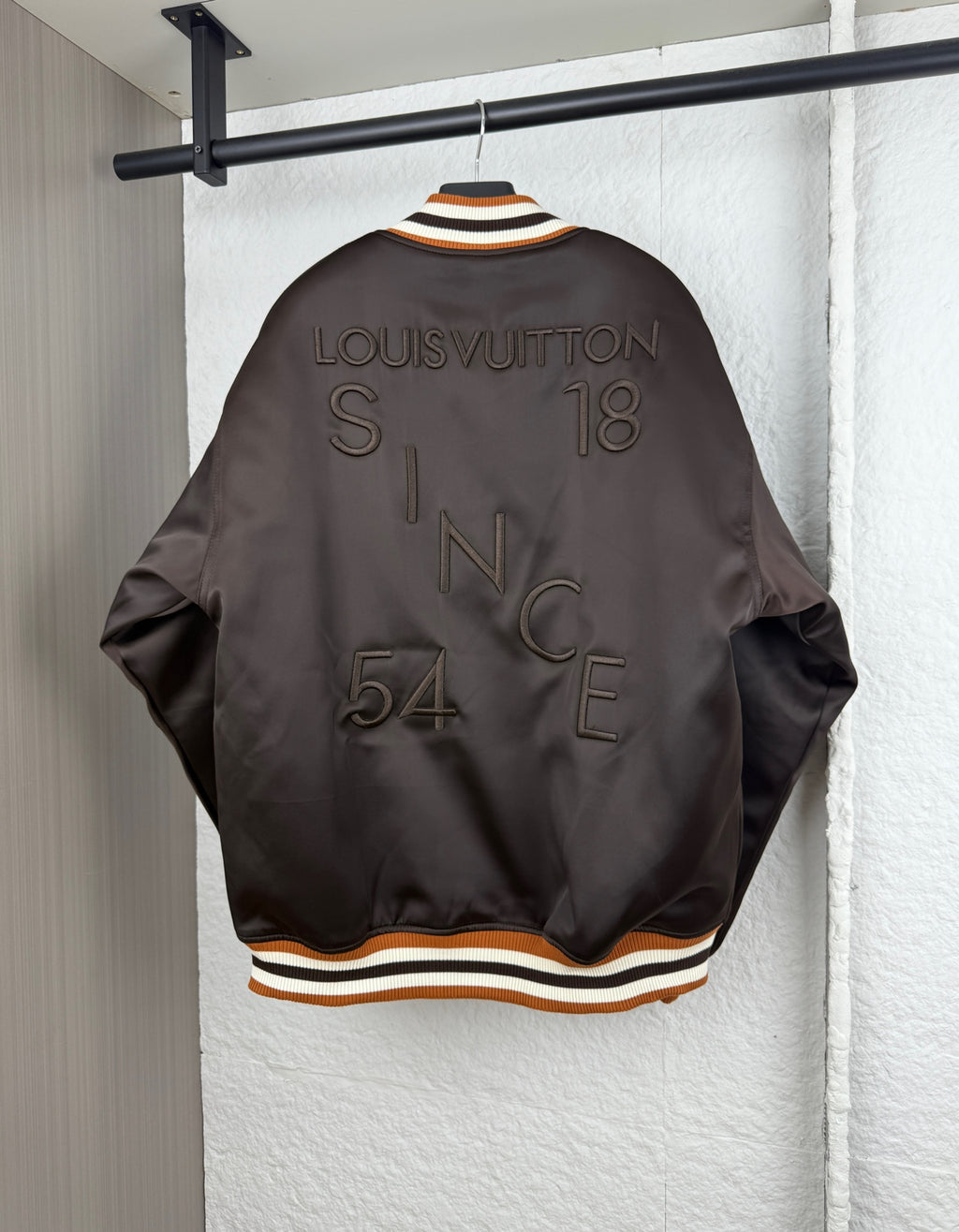 Louis Vuitton bomber jacket, dark satin with ribbed striped hem and back logo
