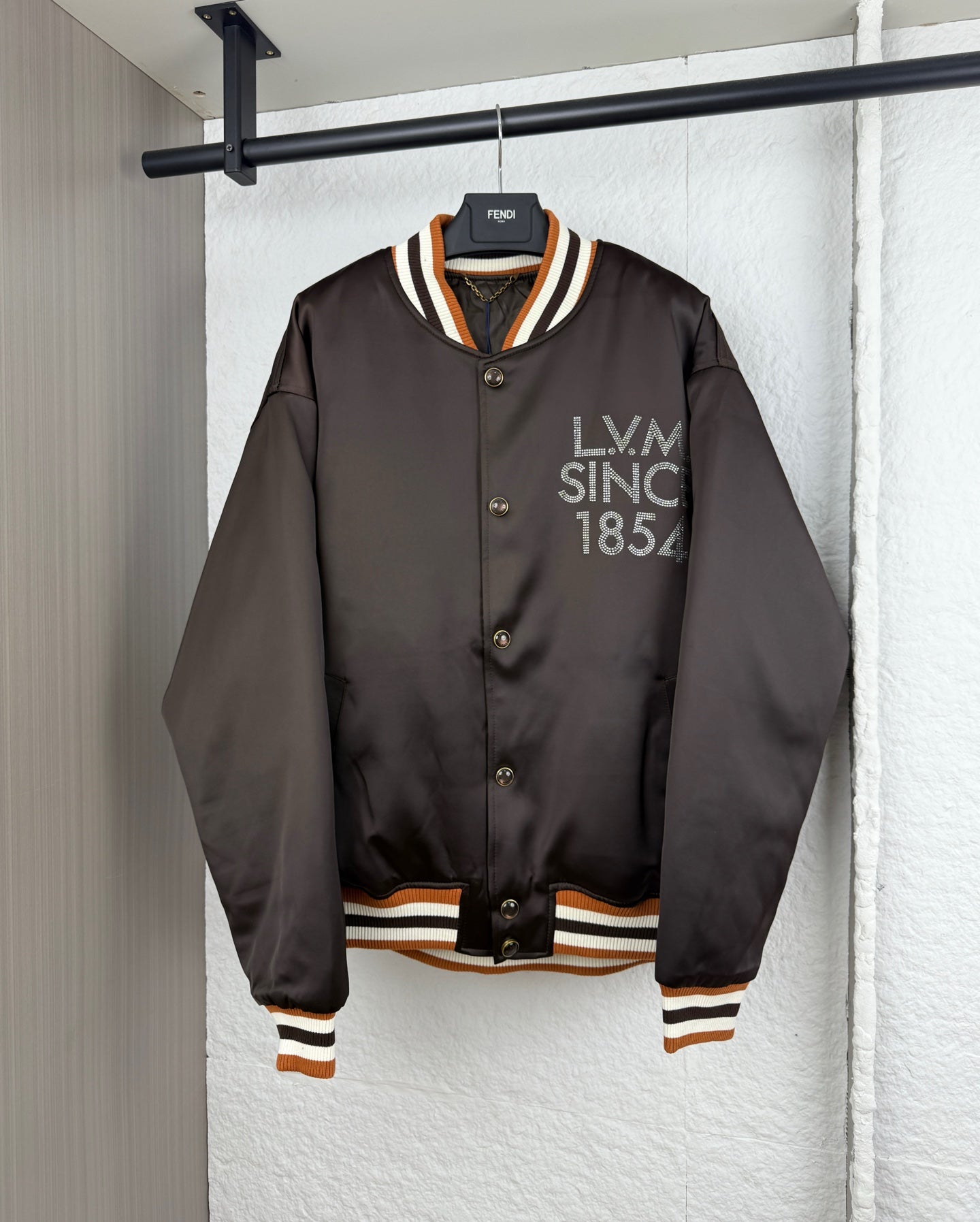 Long-sleeve bomber jacket with snap buttons and striped ribbed trim at cuffs and hem