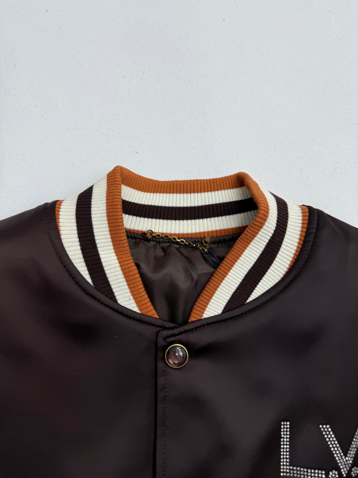 Bomber jacket collar with striped ribbing and snap button placket