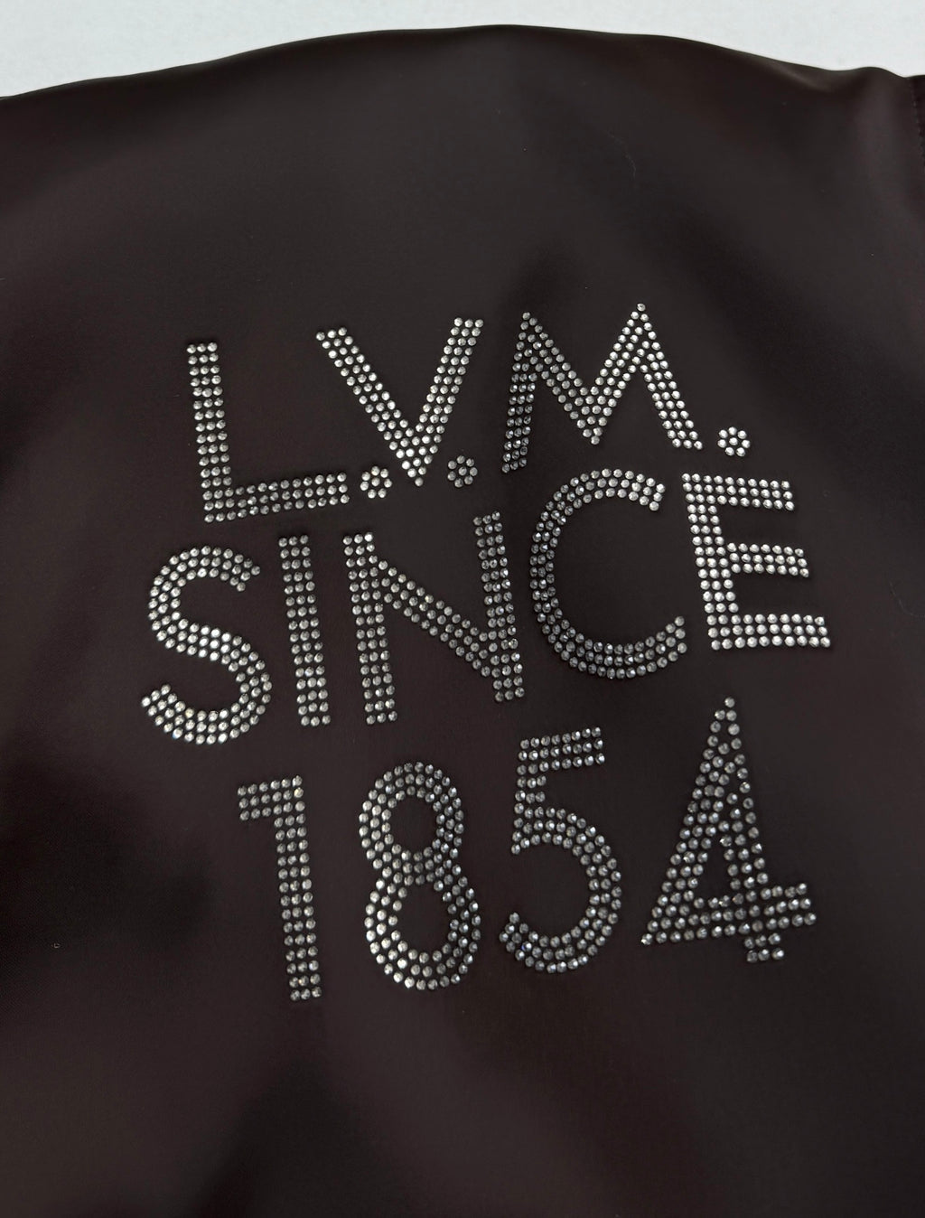 Bomber jacket back with rhinestone-style “LV” and “SINCE 1854” text