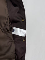 Bomber jacket with interior size tag visible near button placket
