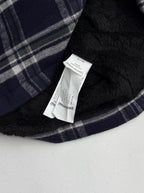 Plaid shirt-jacket inner lining with white brand label tag on navy fabric