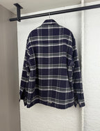 Plaid long-sleeve shirt-jacket back view with button cuffs, navy and white grid pattern