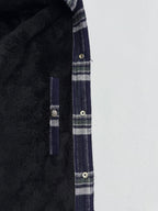 Plaid shirt-jacket side seam and pocket detail with metal snaps, navy and white checks