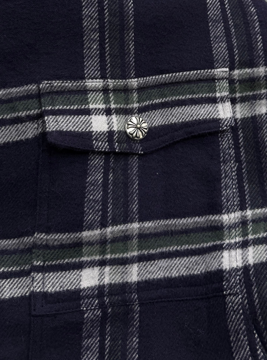 Plaid shirt-jacket chest pocket flap with metal button, navy and white grid pattern