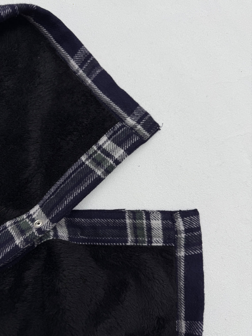 Plaid shirt-jacket shoulder and placket with snap buttons, navy and white checks
