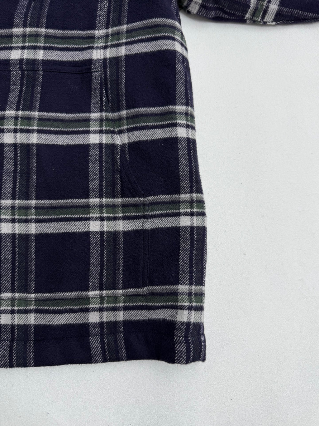 Plaid shirt-jacket side panel with vertical seams, navy and white check print