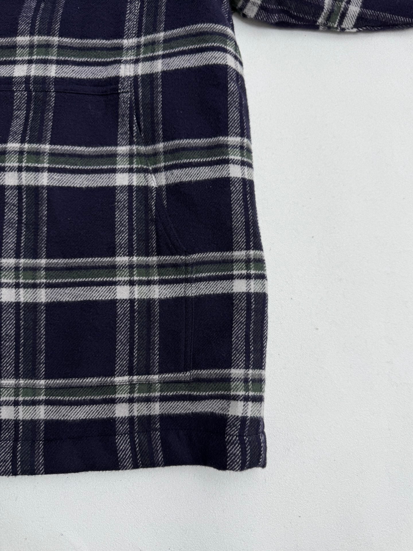Plaid shirt-jacket side panel with vertical seams, navy and white check print