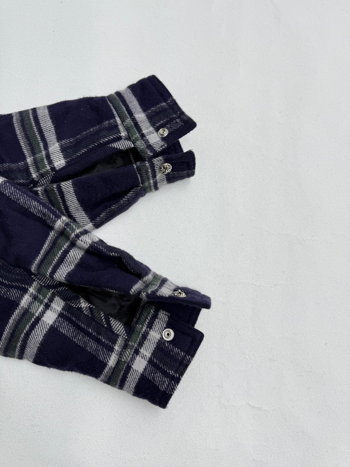 Plaid shirt-jacket sleeve cuff with two buttons, navy and white checked pattern