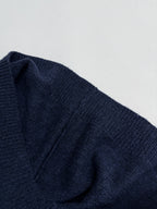 Navy knit sweater draped shoulder seam and knit texture detail