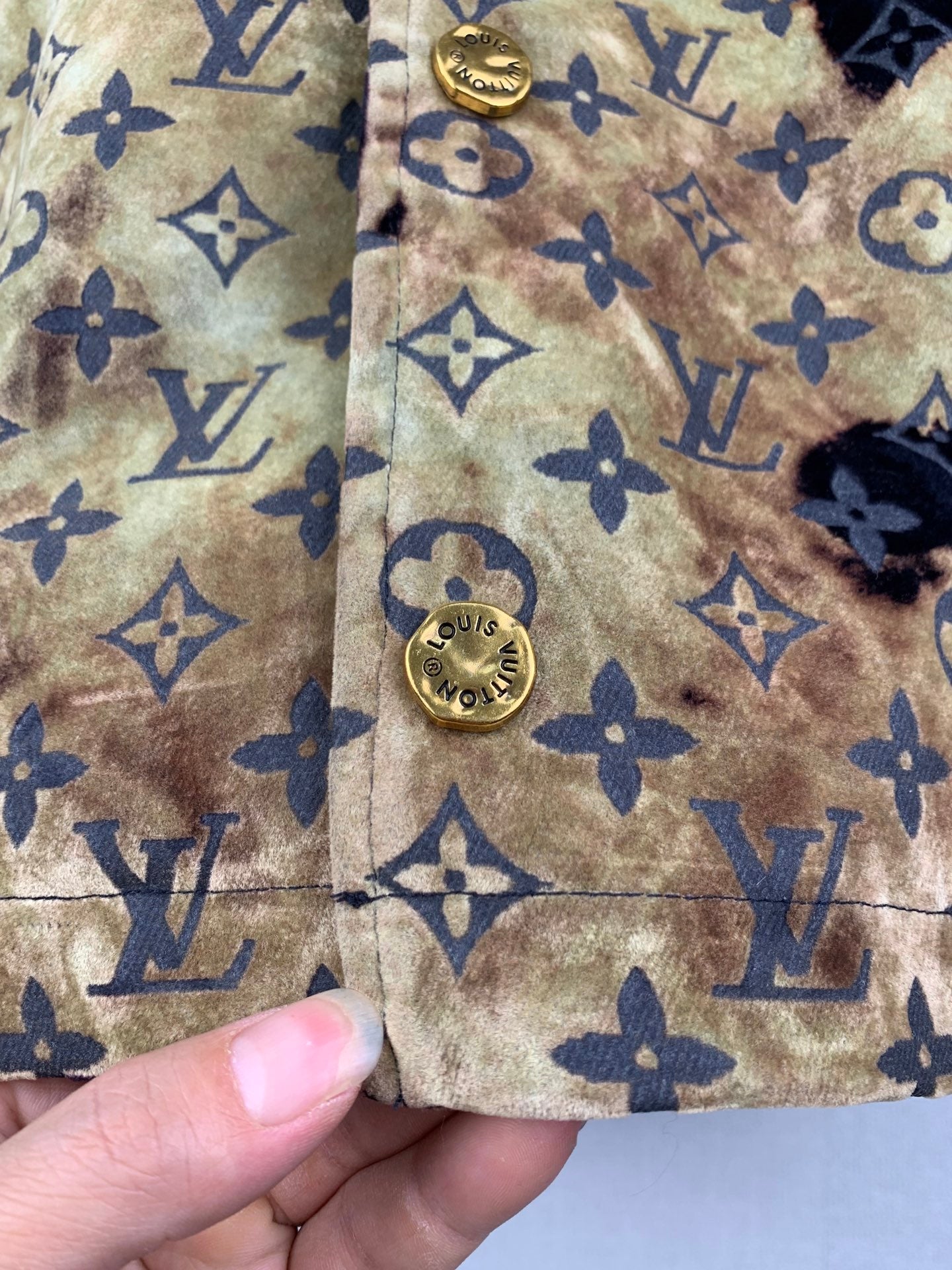 Louis Vuitton long jacket seam detail, tan-gold monogram fabric with navy emblem