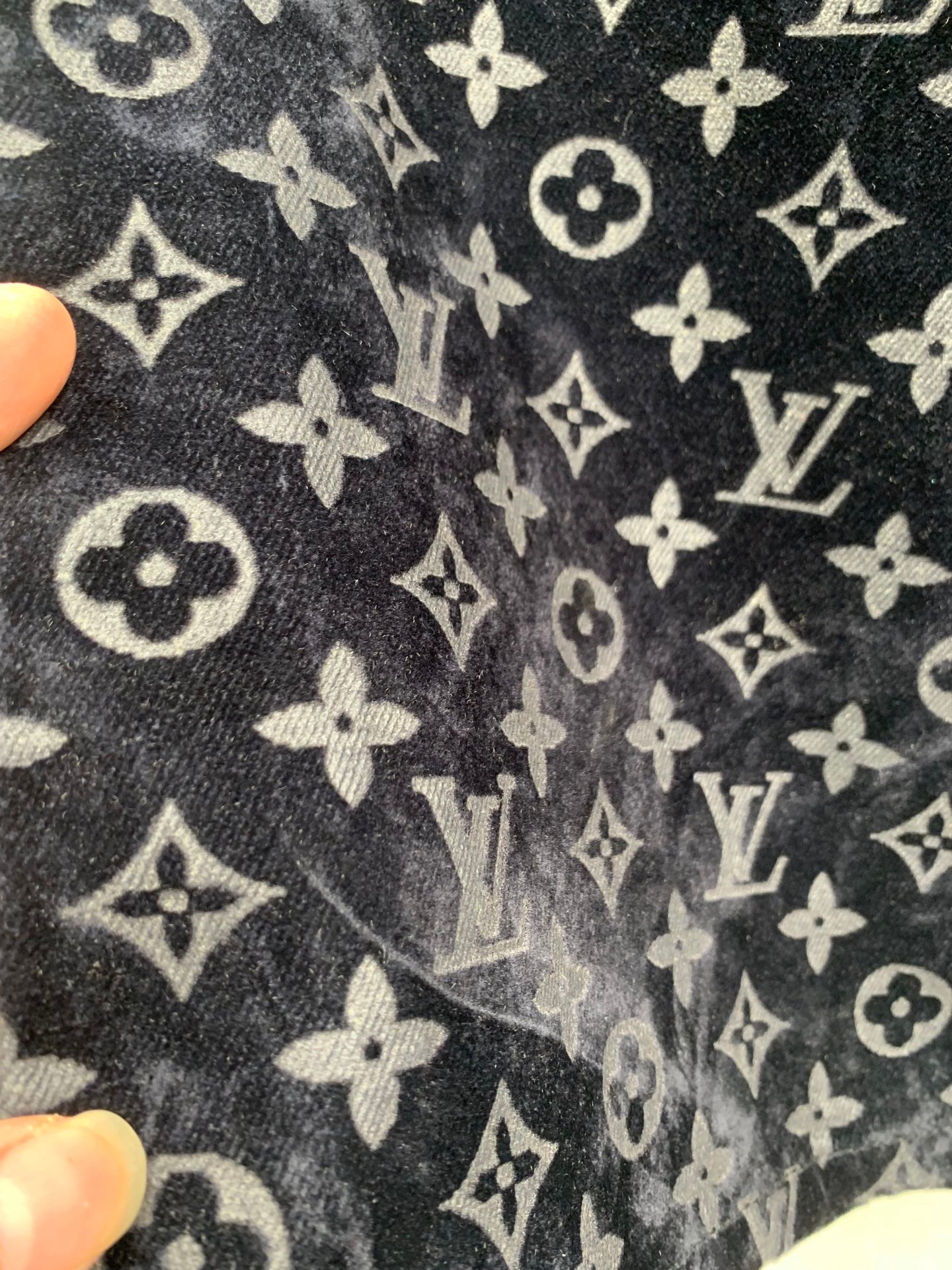 Louis Vuitton monogram long pants fabric close-up, dark blue with light logo print
