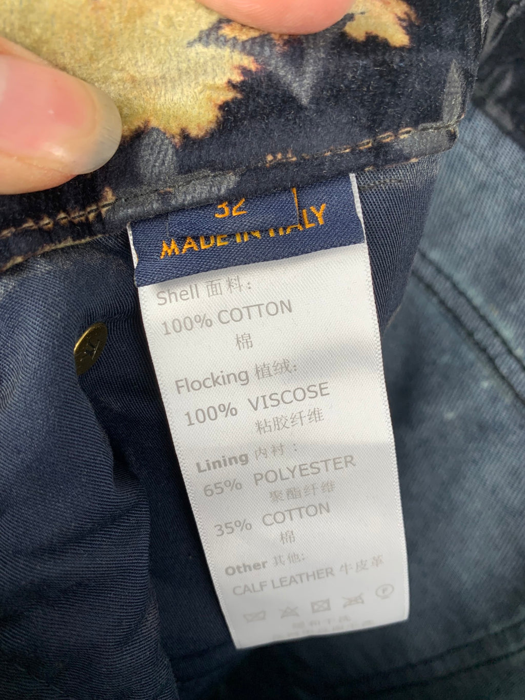 Louis Vuitton jeans care label reading Made in Italy and cotton blend