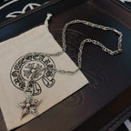 Silver chain necklace with star pendant on white pouch and dark box