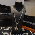 Silver chain necklace with star pendant on bust display, angled view