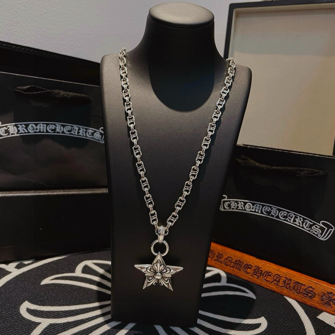 Silver chain necklace with star pendant on bust display, angled view