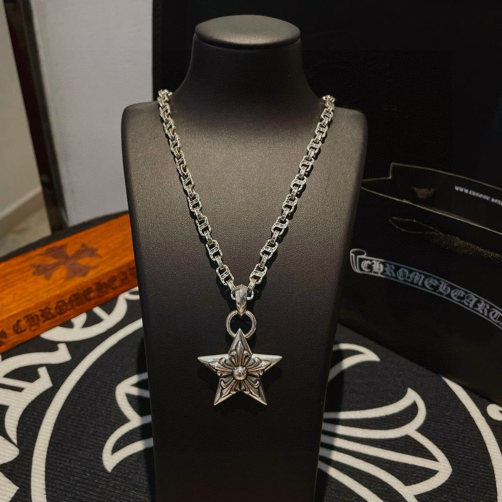 Silver chain necklace with star pendant, front view on bust display