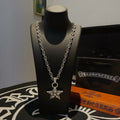 Silver chain necklace with star pendant on bust display