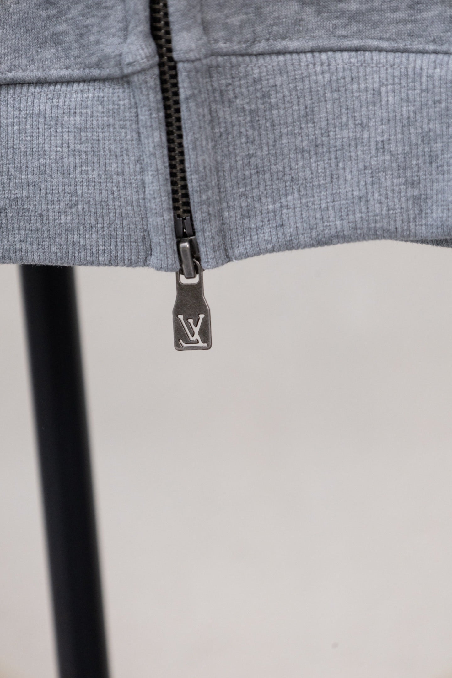 Gray zip-up sweatshirt with LV-logo zipper pull