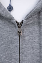Light gray Louis Vuitton zip-up hoodie with metal zipper pull and closed collar.