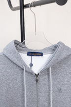 Light gray Louis Vuitton zip-up hoodie hood, drawstrings, and front zipper.
