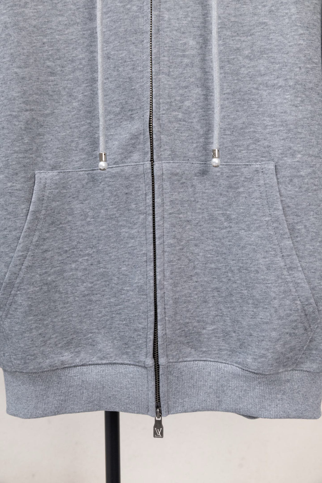 Light gray zip-up hoodie with kangaroo pocket and two drawstring cords.