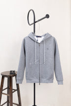 Light gray zip-up hoodie with hood and drawstring cords, long sleeves.