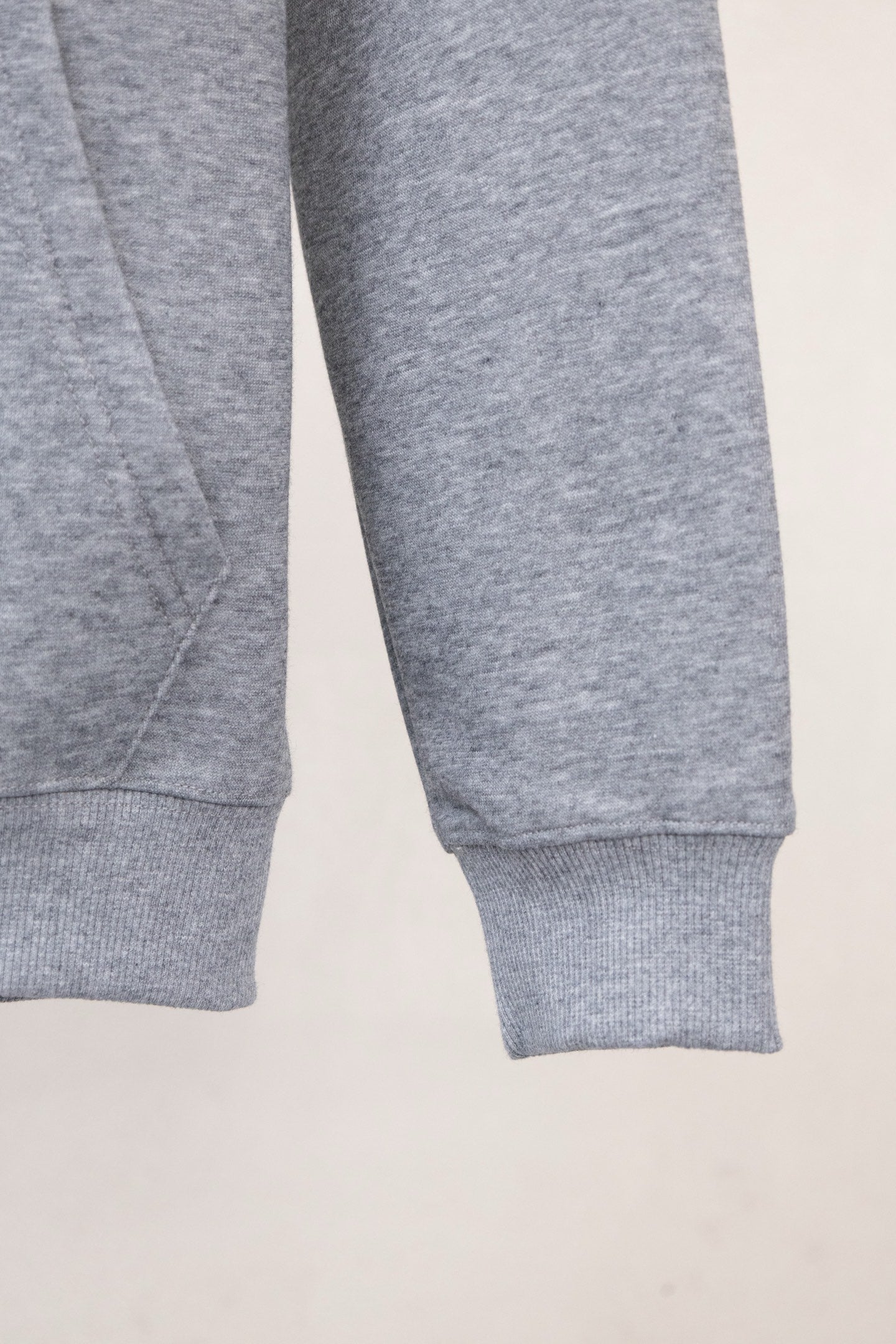 Gray sweatshirt sleeve with ribbed cuff and stitched hem