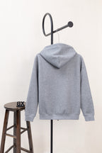 Light gray hoodie from back view with hood and drawstring cords, long sleeves.