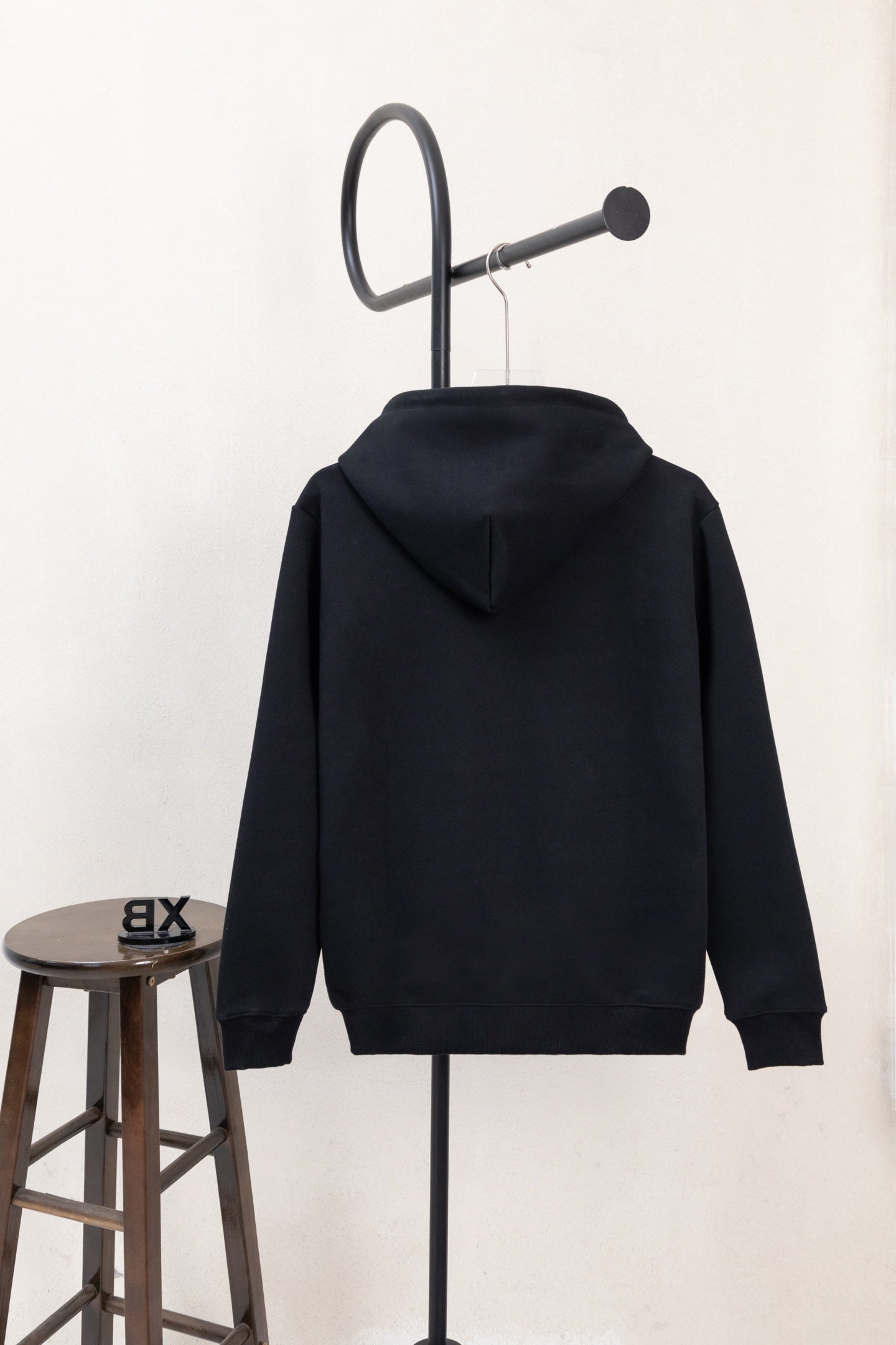 Dark navy zip-up hoodie back view with hood and ribbed cuffs
