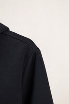 Dark navy hoodie shoulder and sleeve side seam with structured collar