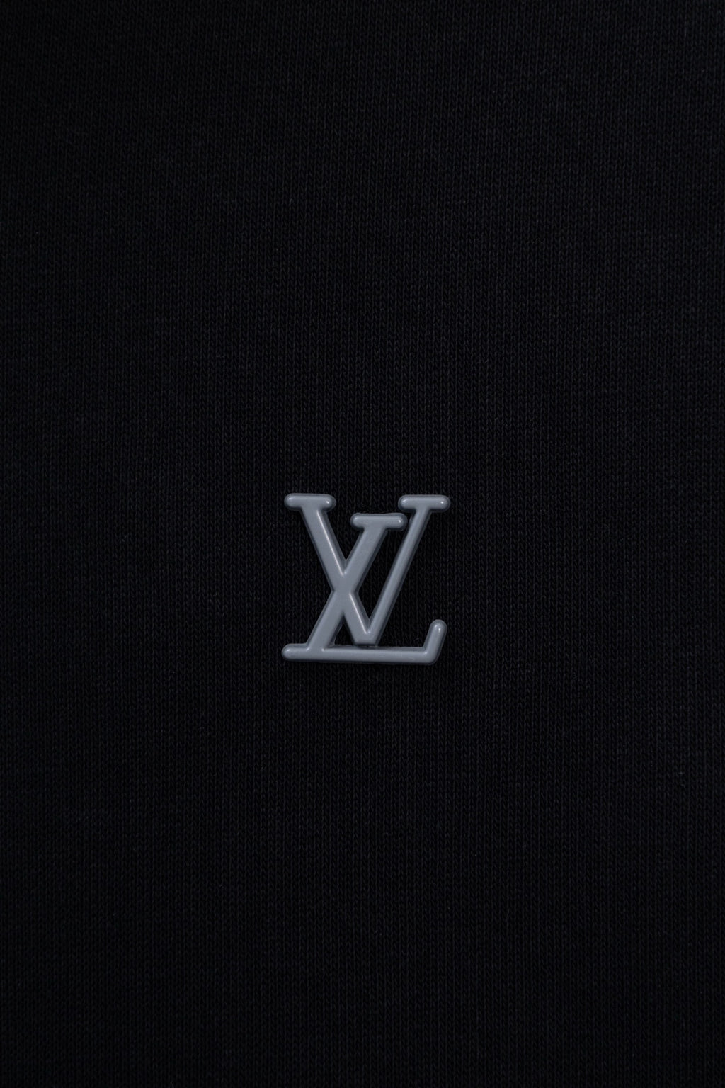 Dark navy hoodie chest with small silver-tone LV monogram logo