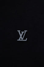 Dark navy hoodie chest with small silver-tone LV monogram logo