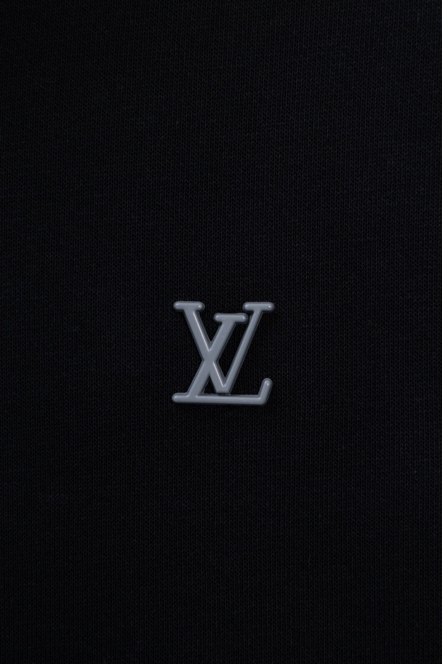 Dark navy hoodie chest with small silver-tone LV monogram logo