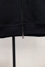 Dark navy hoodie hem and cuff close-up with center zipper and small LV mark