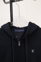 Dark navy zip-up hoodie close-up at hood and front neckline with metal zipper