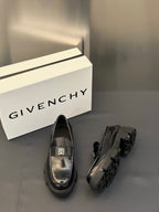 Black leather loafers with silver logo buckle and platform rubber heel